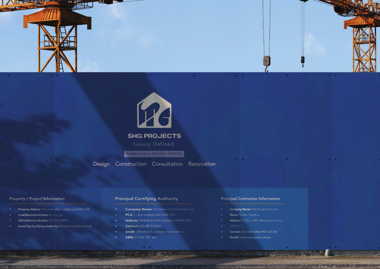 Large-format blue construction site hoarding displaying the SHG Projects brand identity and project compliance information below yellow tower cranes
